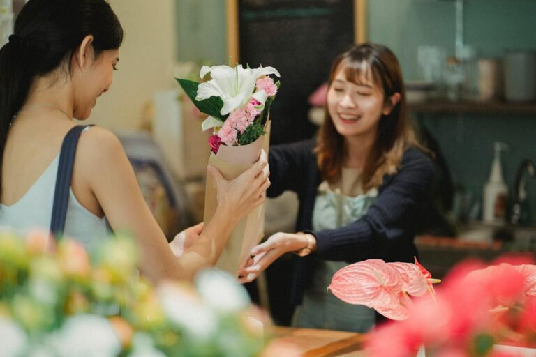 Support Local Business – Shop Small Business Saturday - woman handing flower to another woman