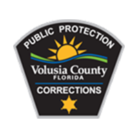 Public Protection Volusia County Florida Corrections logo with a gold star and the sun