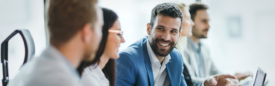 Licensing Your Business banner - people in a board room smiling