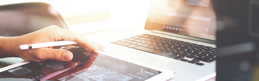 Paying Business Taxes - person in front of computer using a tablet with stylus