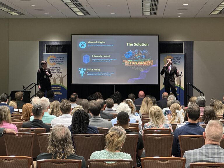 Volusia Innovation Challenge finalist Beyond Bounds pitching their business on the stage with audience in foreground