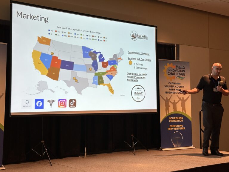 Photo of a finalist pitching his business showing a map of the US for marketing efforts