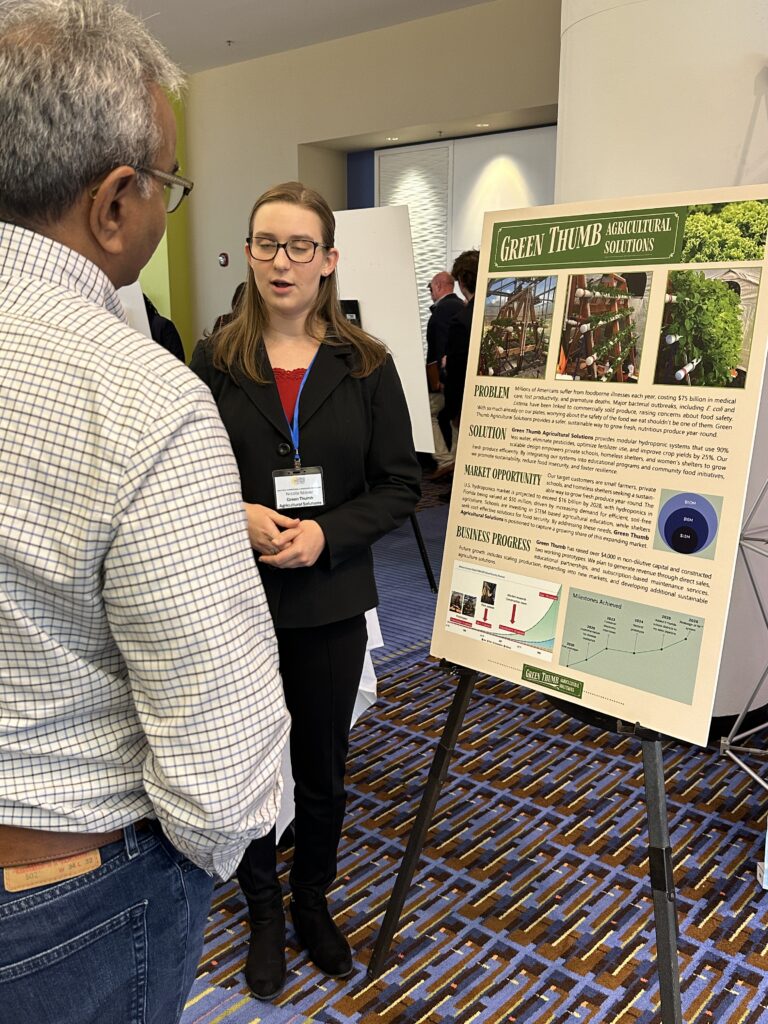 Volusia Innovation Challenge Showcase exhibitor Green Thumb Agricultural solutions speaking to a guest