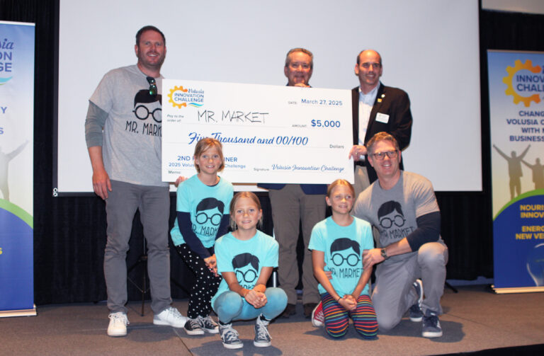 Mr. Market founder Jack White holding the 2nd place big check for $5000 with Volusia Innovation Challenge team members, his children and brother