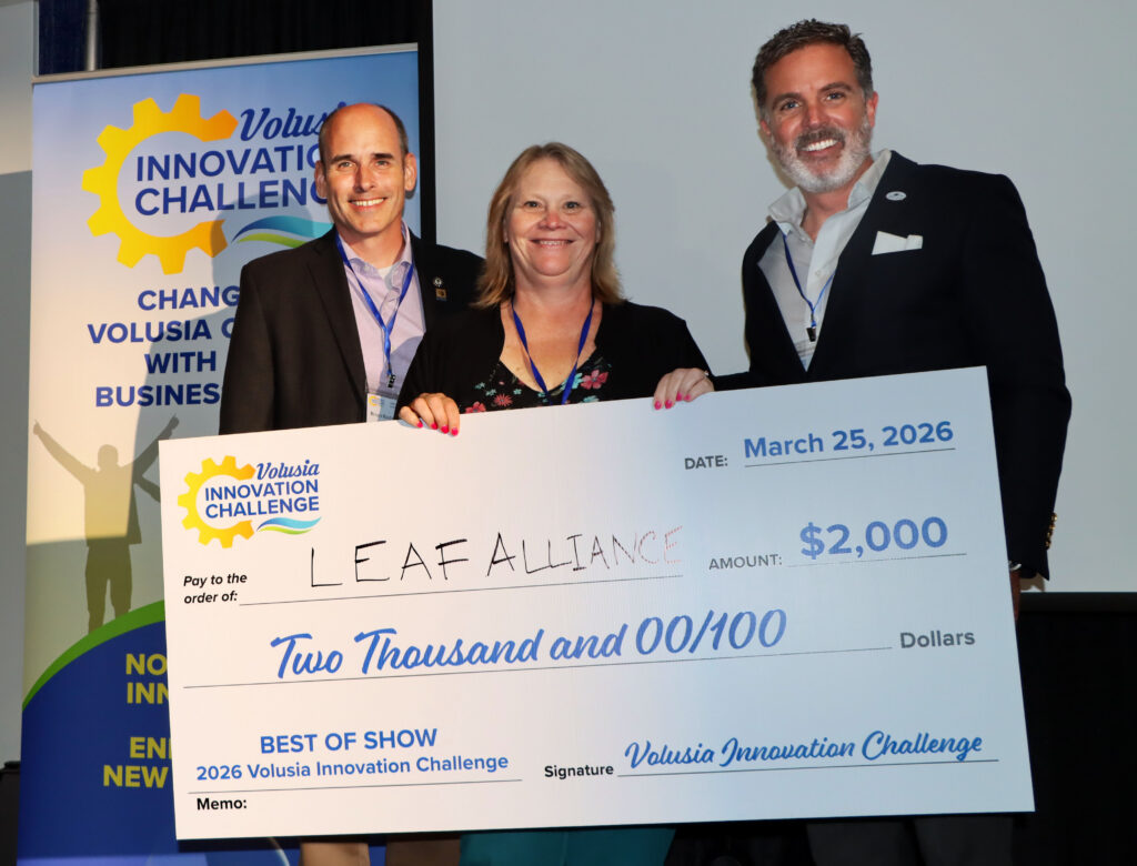 Group photo with representatives from economic development organizations and the People's Choice voter determined Best of Show winner holding the big check for $2,000 for her business LEAF Alliance.