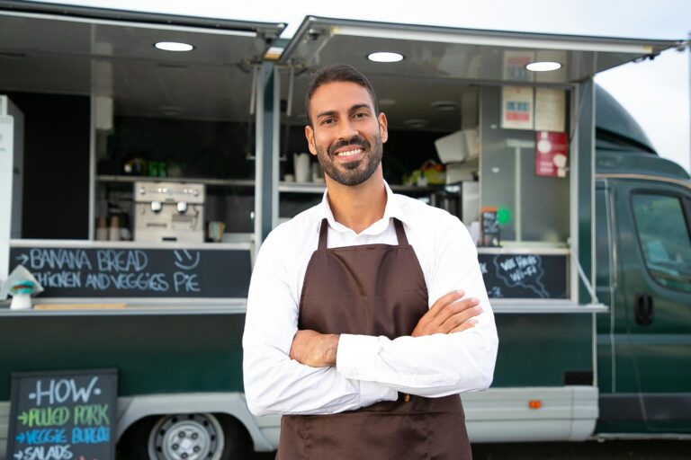 entrepreneur standing in front of his food truck