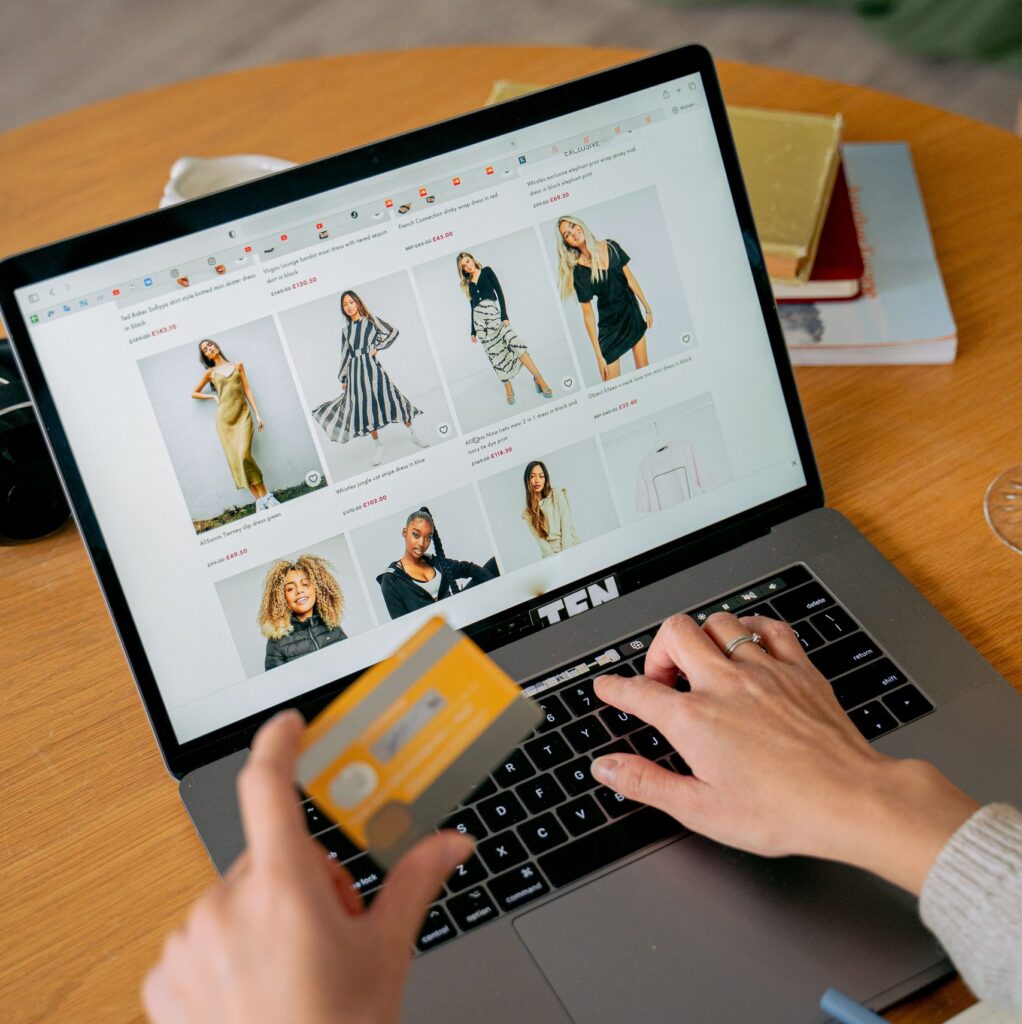 A person in front of a laptop making an online purchase