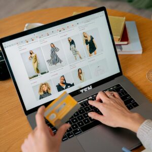 A person in front of a laptop making an online purchase